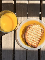A refreshing glass of fresh juice placed on a wooden table near the window.