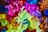 A collection of colorful, translucent plastic toy bugs and animals. The toys are piled together in various vibrant hues, including green, pink, yellow, blue, orange, and purple. The details of the textures and shapes of the toys are clearly visible.