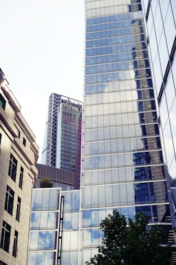 Urban commercial real estate with glass windows reflecting sky