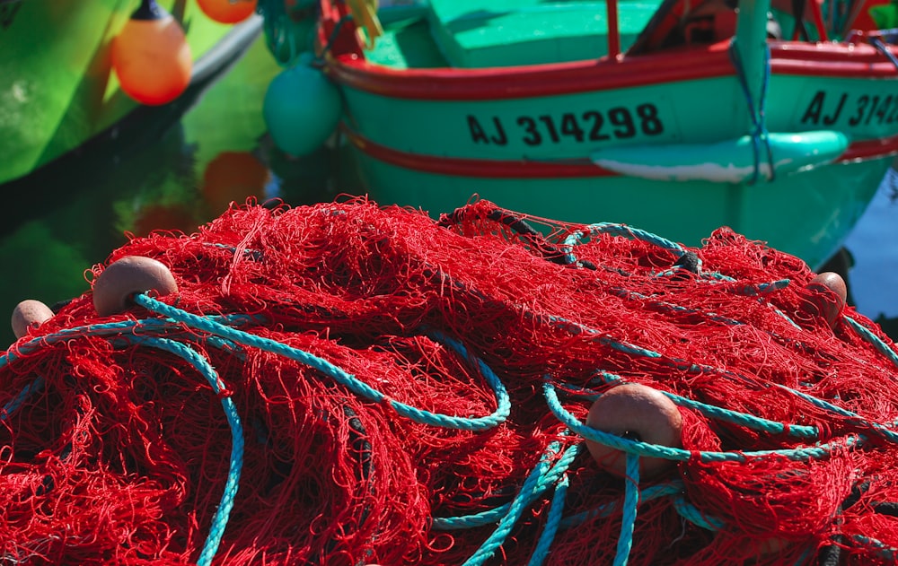 a pile of red fishing nets sitting next to each other