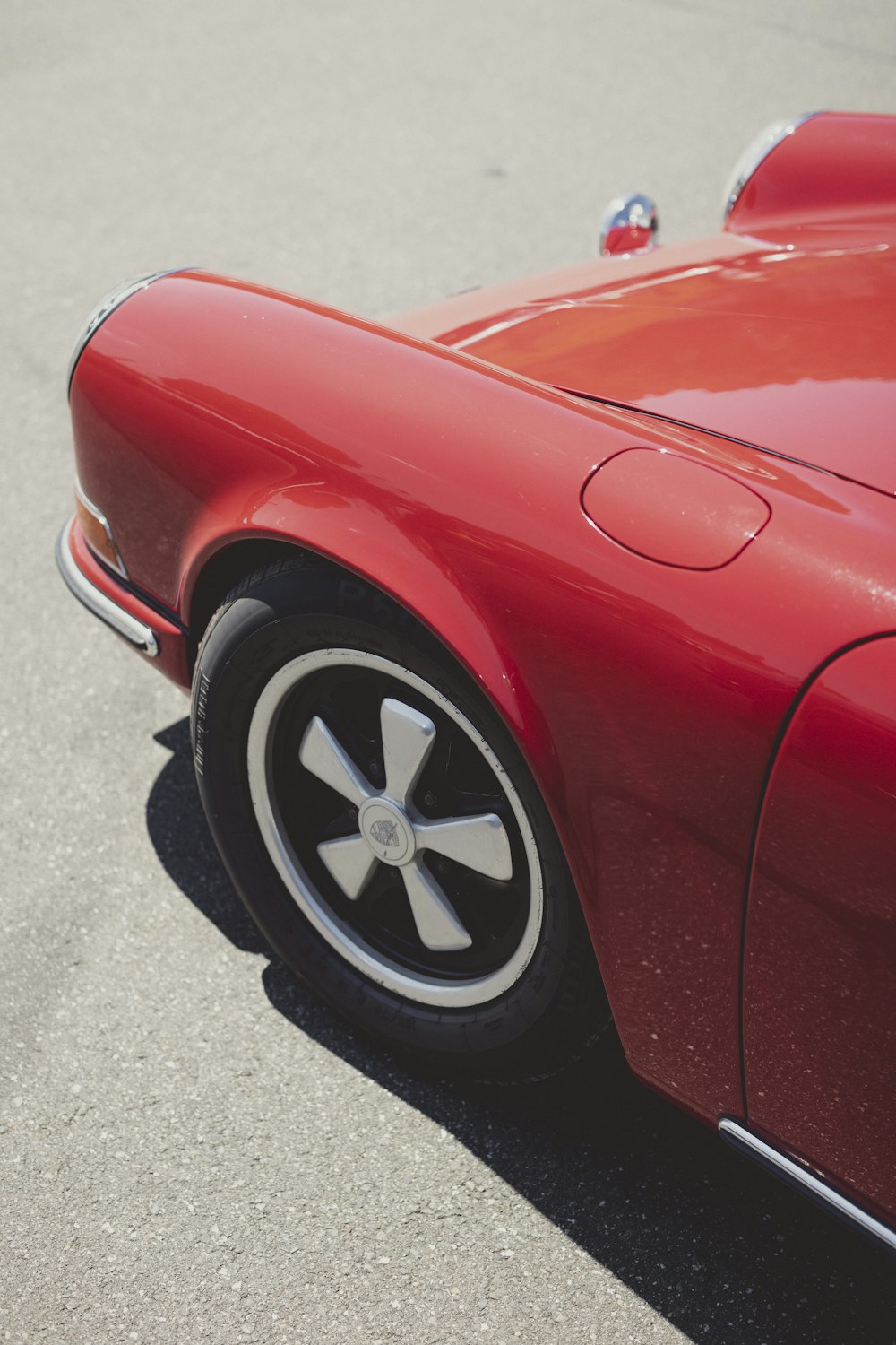 a red sports car parked in a parking lot