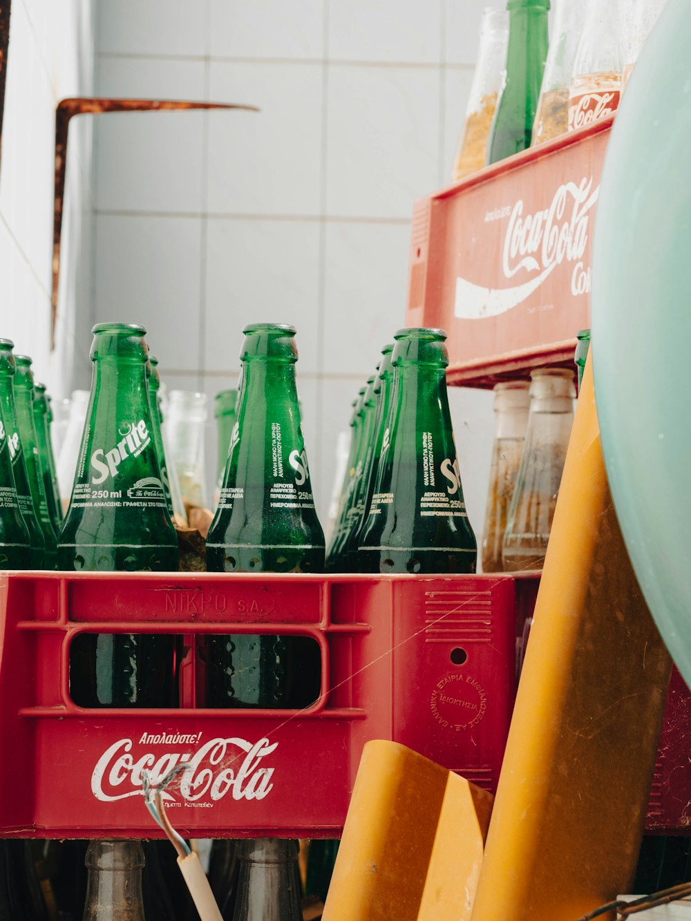 a cart full of green and red coca - cola bottles