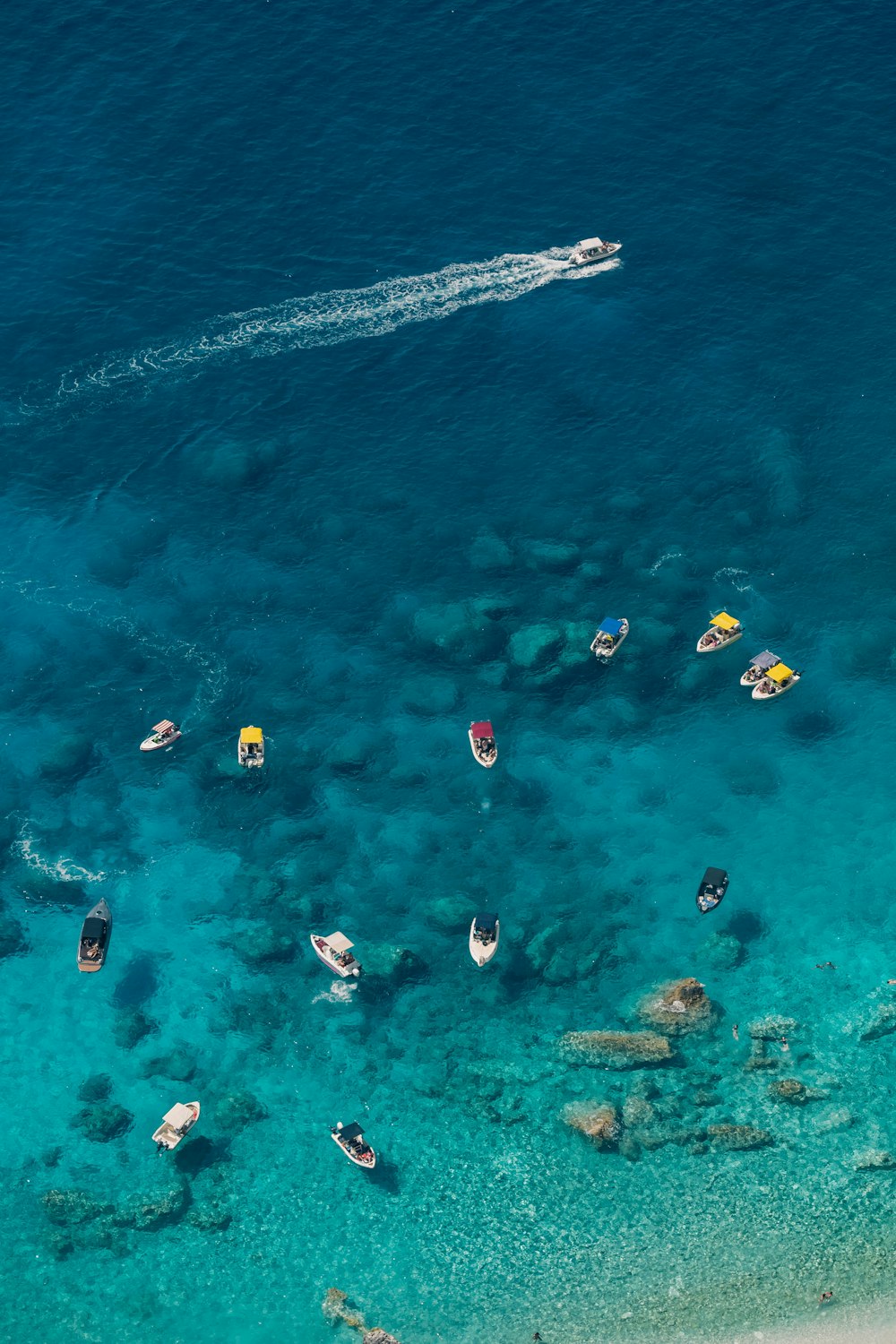 a group of boats floating on top of a body of water