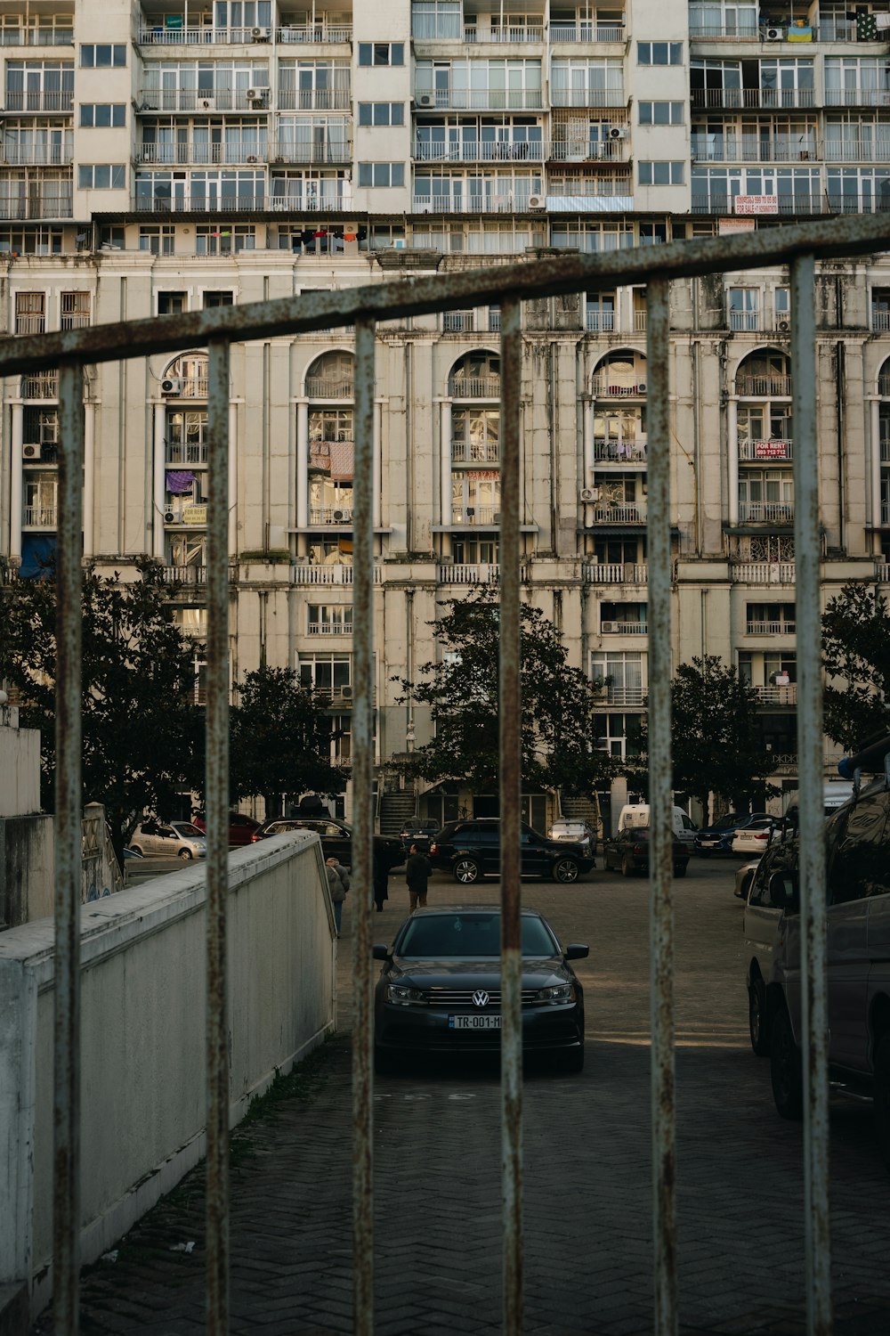 a car parked in front of a tall building