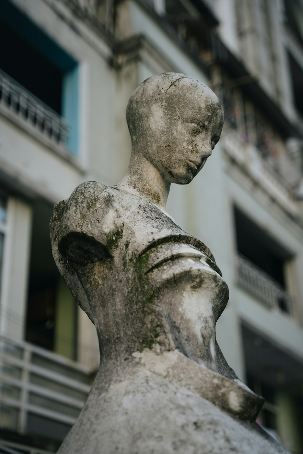 a statue of a woman in front of a building