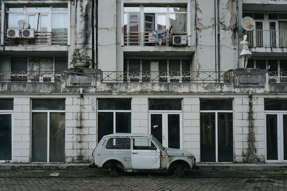 an old car parked in front of a building