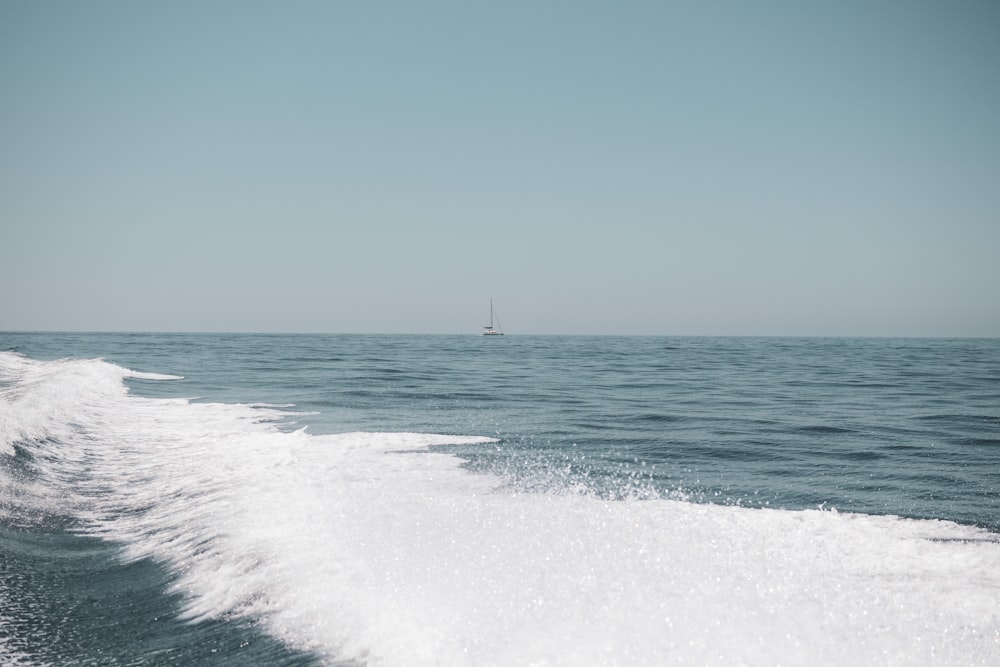 the wake of a boat in the middle of the ocean