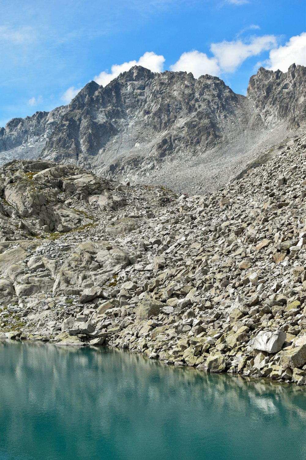 a mountain range with a body of water in the foreground