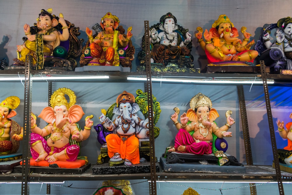 a shelf filled with lots of different colored statues