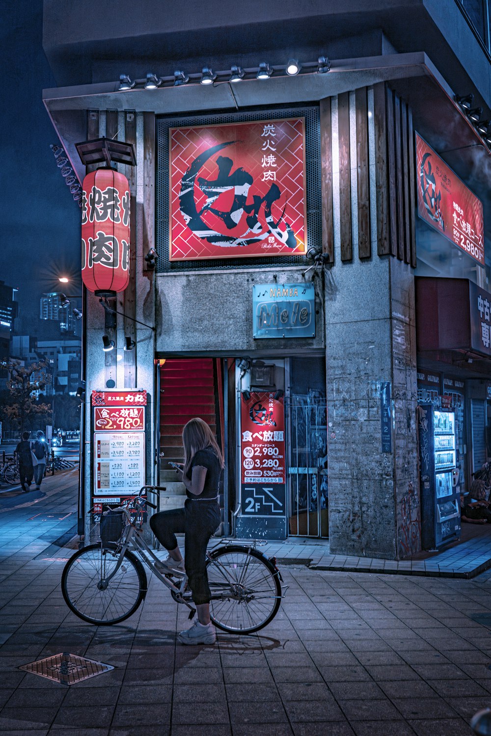 a woman sitting on a bike in front of a building