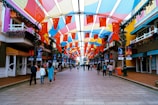 A vibrant street scene filled with colorful banners and flags.