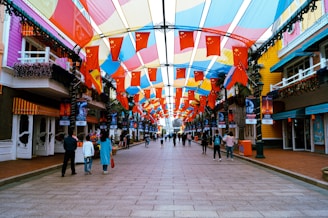 A vibrant street scene in Brazil showing colorful buildings and lively local people celebrating.
