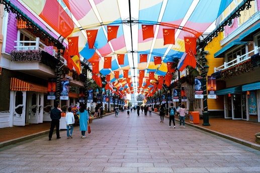 A vibrant street scene in Bangladesh during election day, with colorful banners and people casting votes.