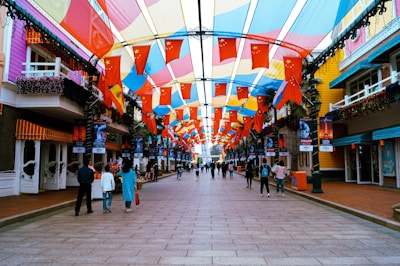 A vibrant street scene filled with colorful banners and flags.