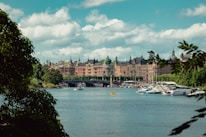 A scenic view of the Ayamonte riverfront with boats docked and colorful buildings.