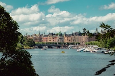 A scenic view of the Ayamonte riverfront with boats docked and colorful buildings.