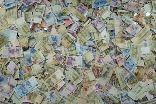 Visual of multiple currency notes and coins symbolizing global money exchange.