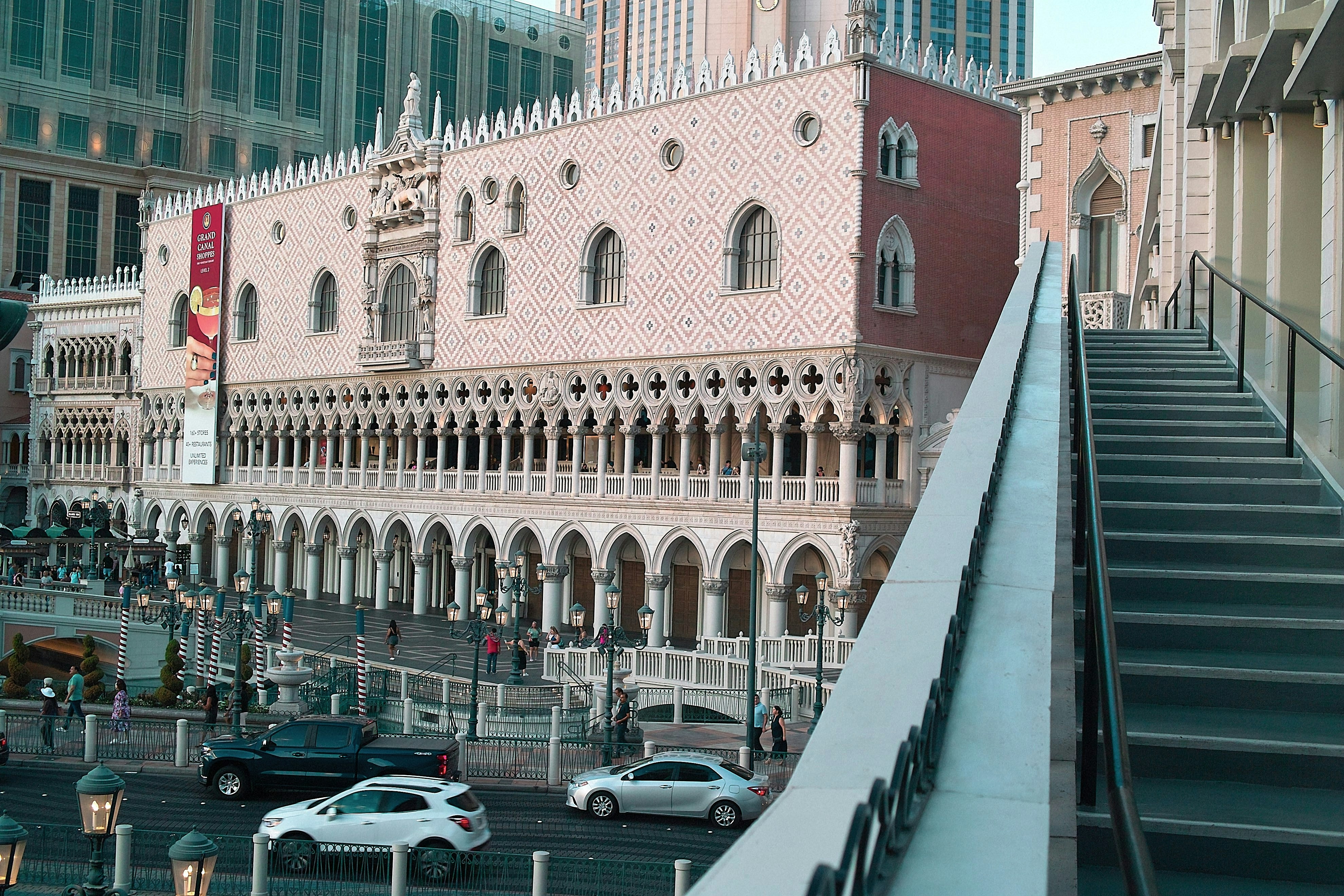 a very tall building with a bunch of cars parked in front of it