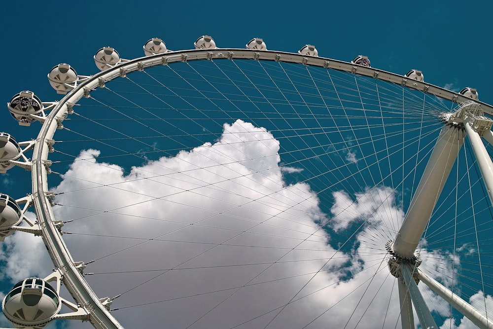 a large ferris wheel sitting under a cloudy blue sky