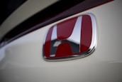Close-up of a Honda logo on the front grille of a vehicle.