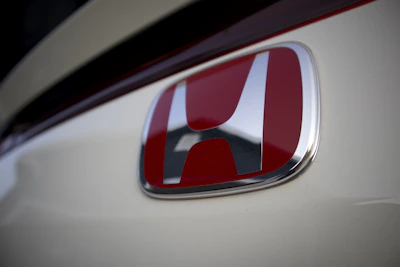 Close-up of a Honda logo on the front grille of a sleek car
