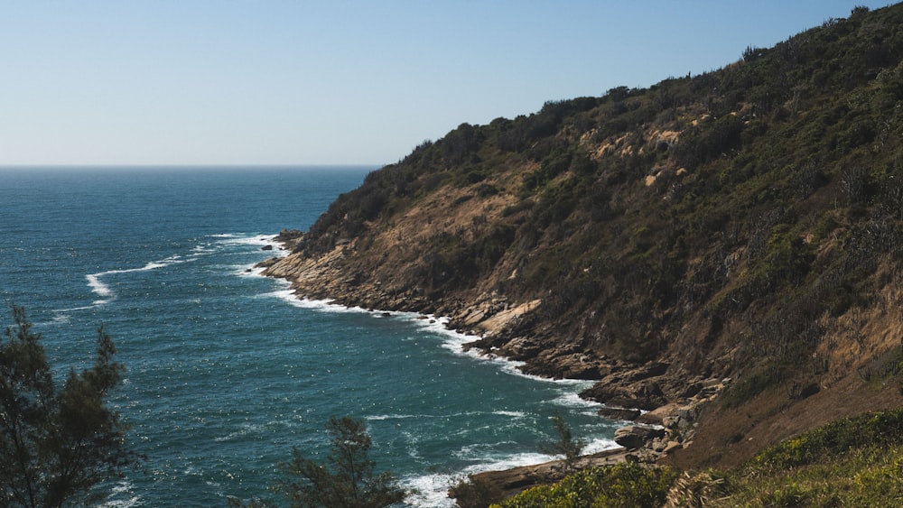 a view of the ocean from the top of a hill