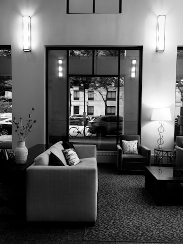 A cozy living room setup featuring stylish rented furniture and appliances with a delivery van parked outside.