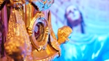 Close-up of religious iconography and subtle blue and beige decorative elements.