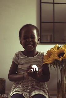 A joyful child holding up a handmade craft inspired by our educational activities, beaming with pride.