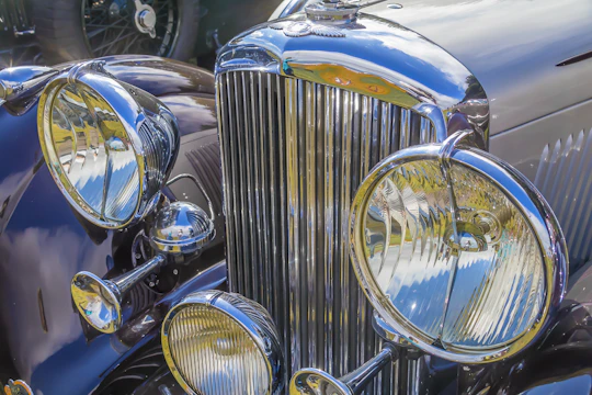 Close-up of the freshly restored chrome grille shining under sunlight.