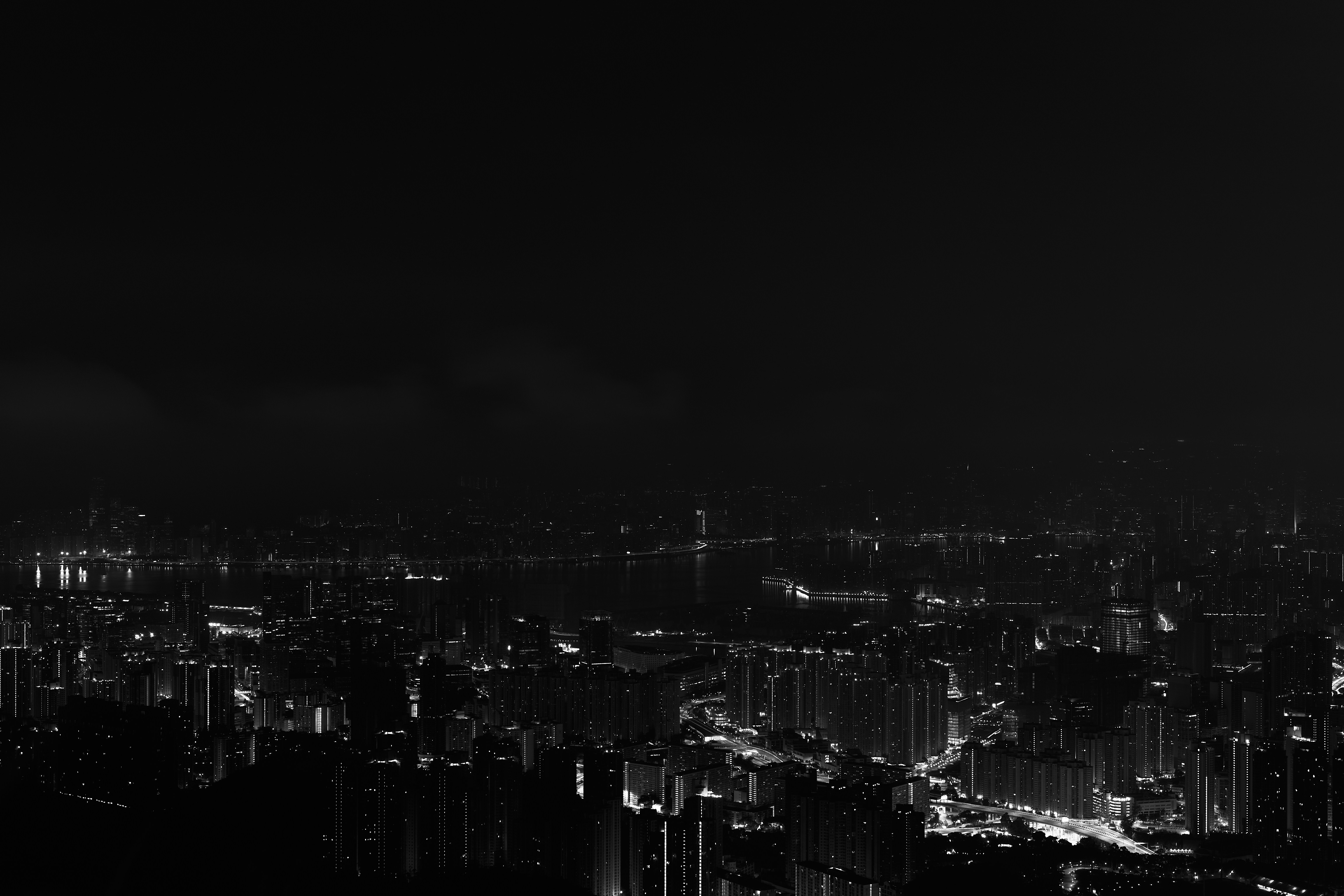 a black and white photo of a city at night