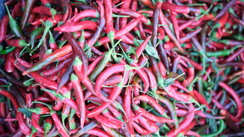 a pile of red peppers and green peppers