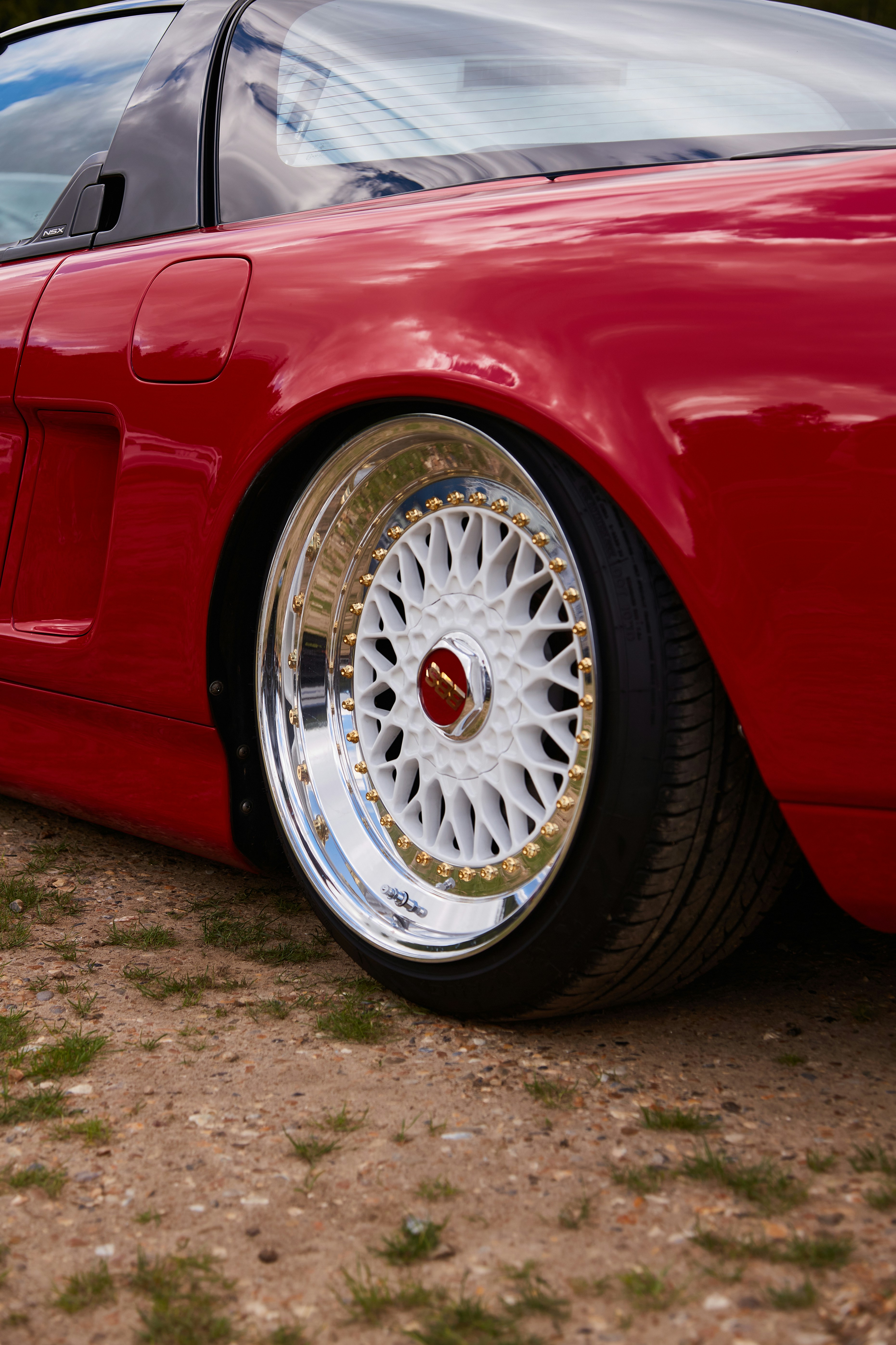 A red sports car parked on a dirt road photo Free Car wallpaper Image