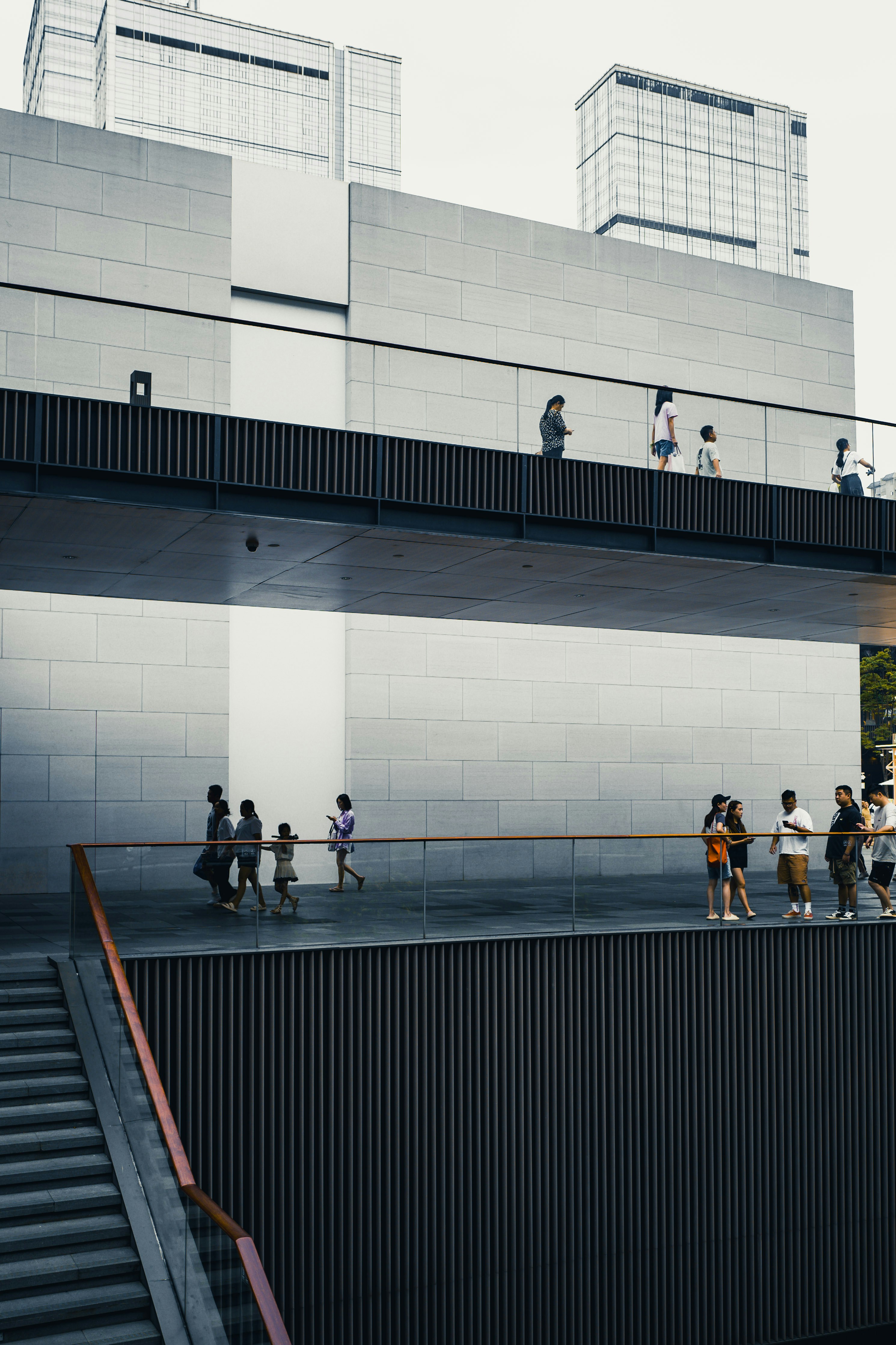 a group of people walking across a bridge