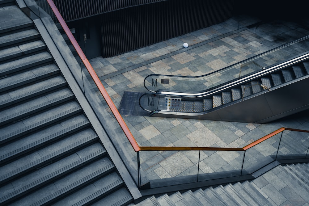 an escalator in a building with a tiled floor