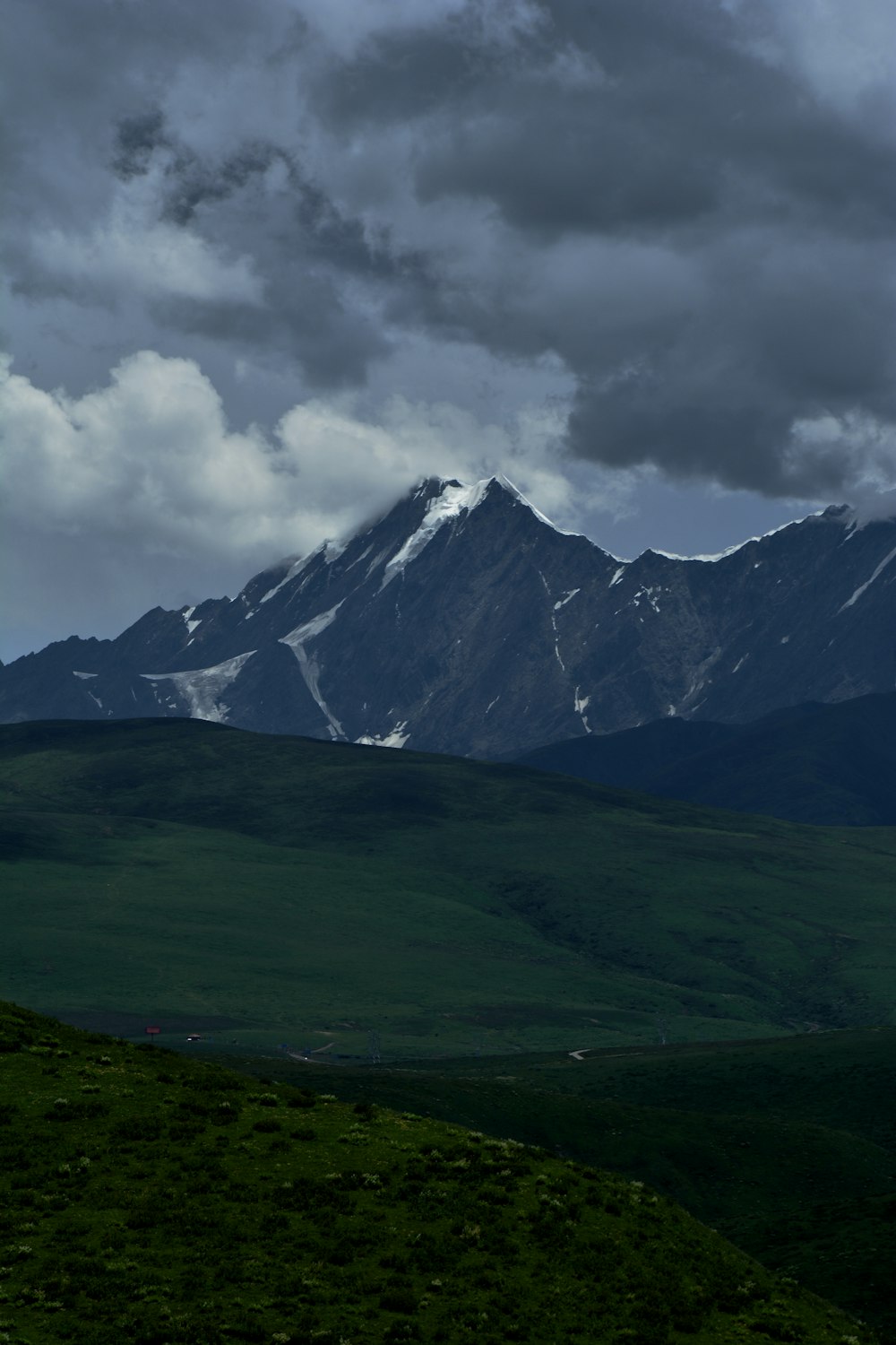 a view of a mountain range under a cloudy sky