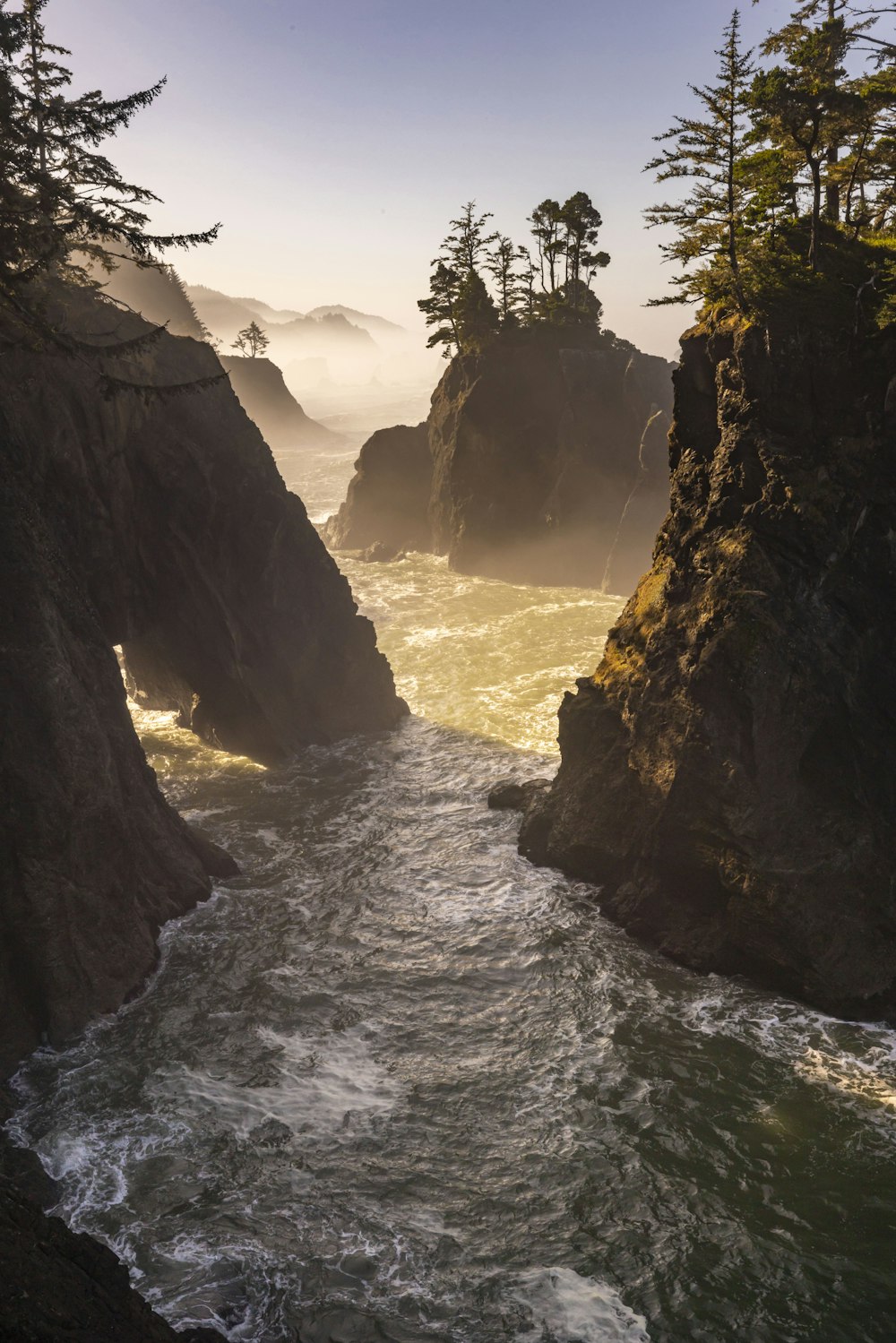 a body of water surrounded by rocks and trees