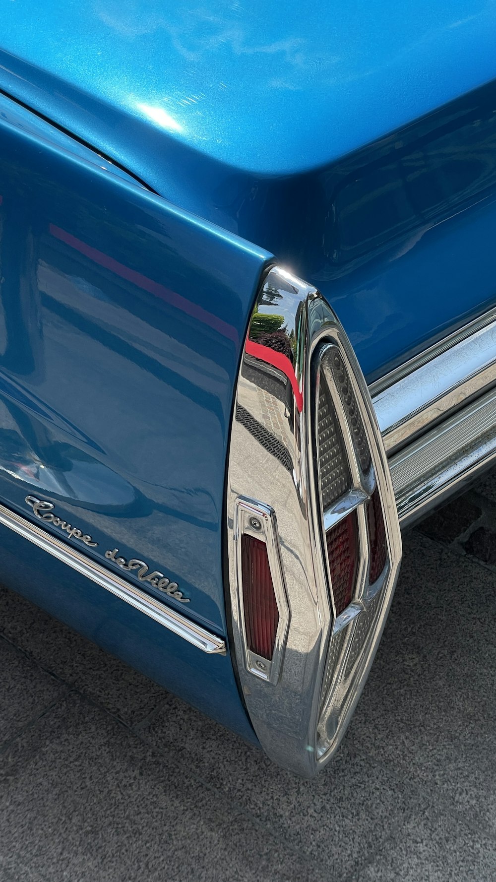 a close up of a blue car's rear end