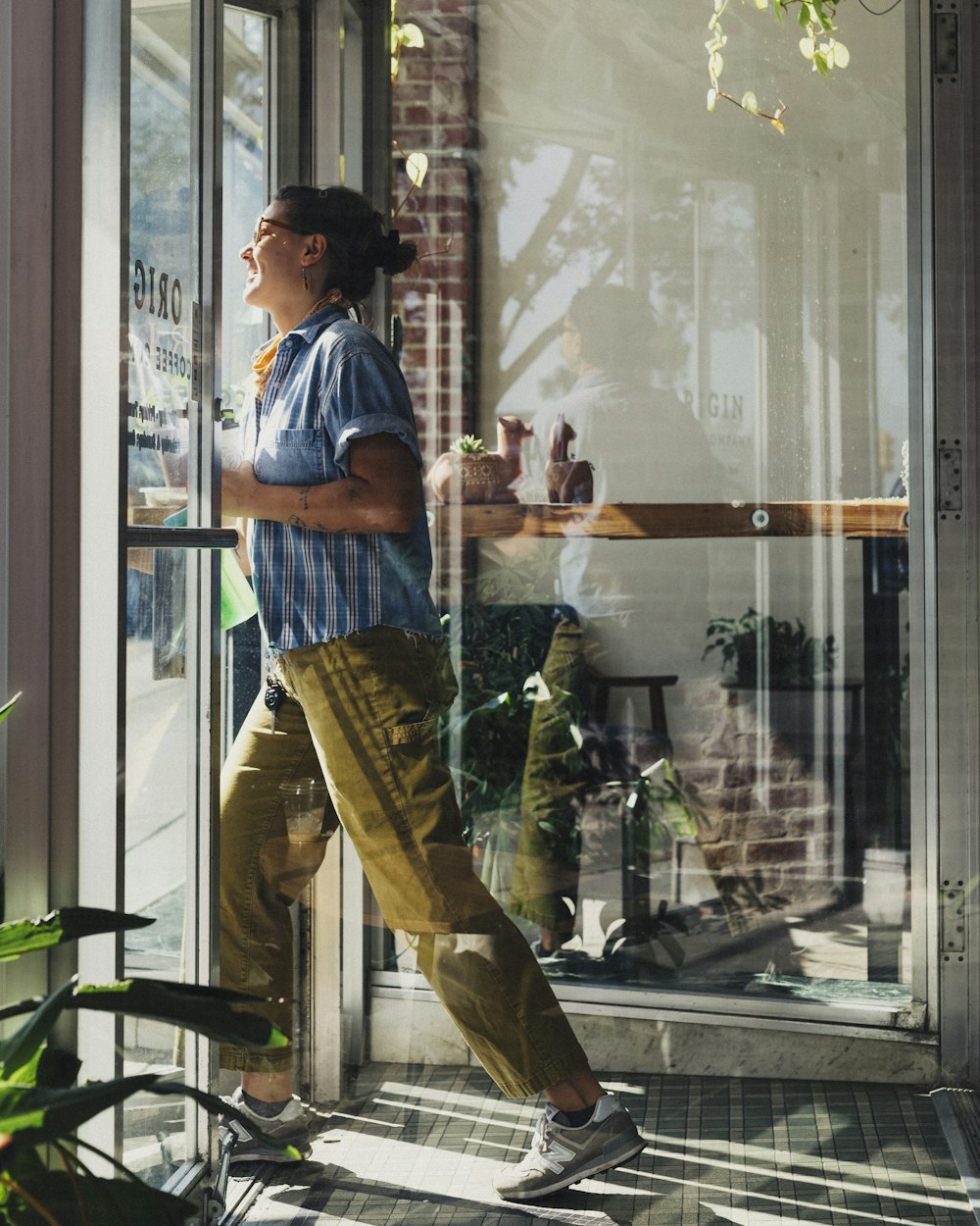 a woman standing outside of a store window