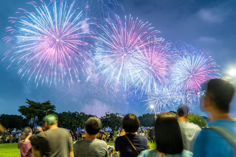 a group of people watching fireworks in the sky