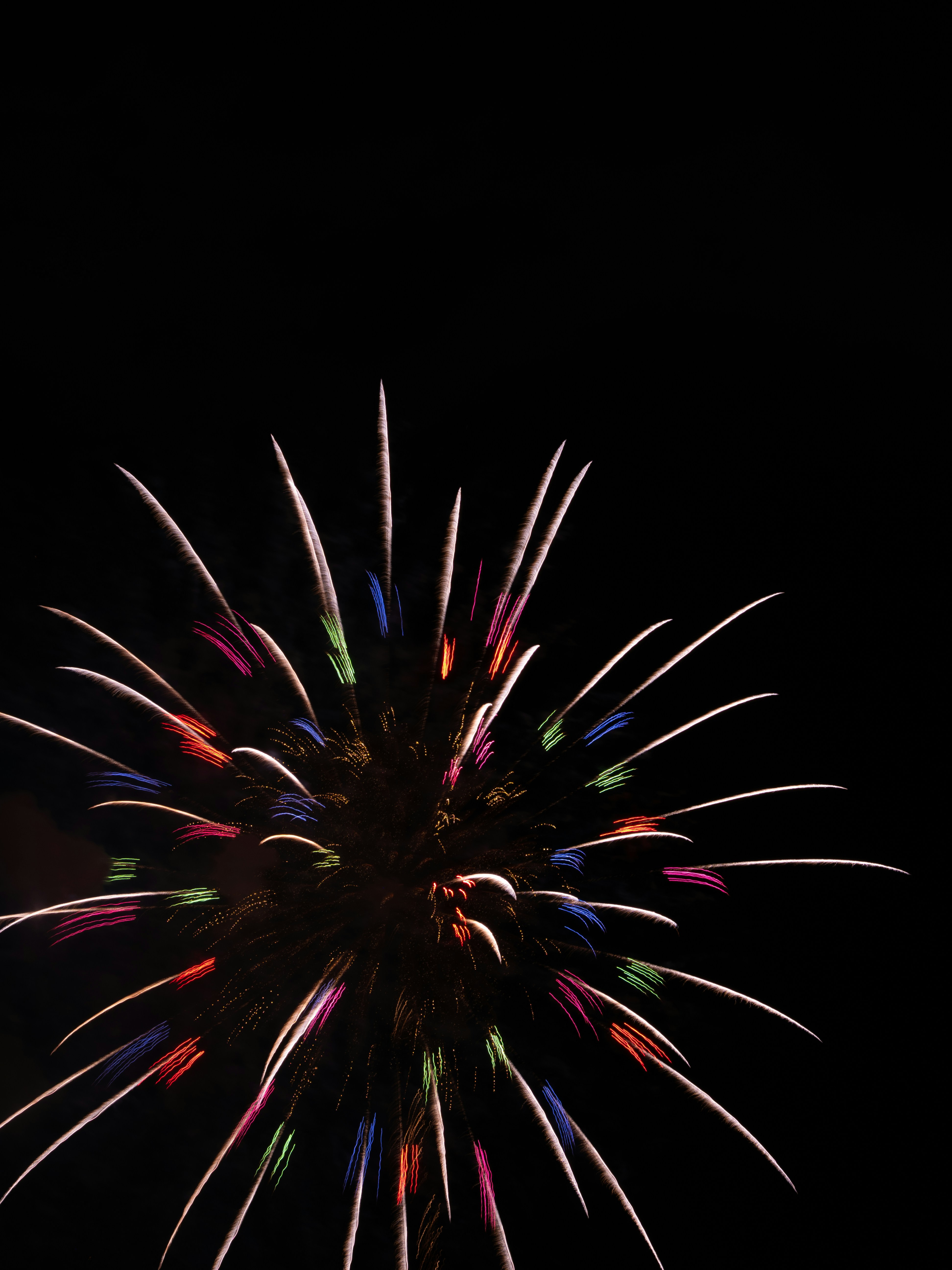 a colorful fireworks is lit up in the night sky