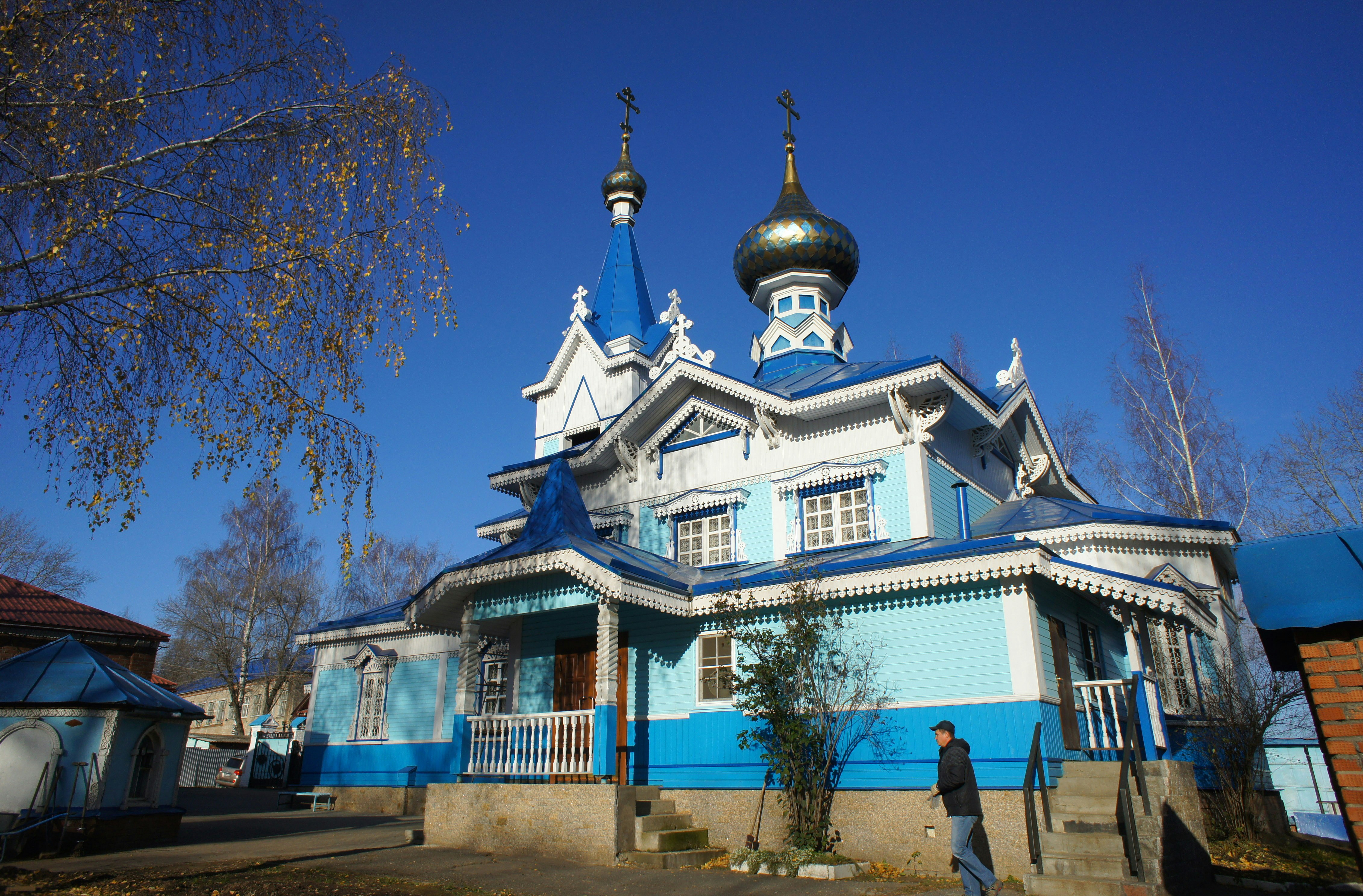 a blue and white building with a gold dome