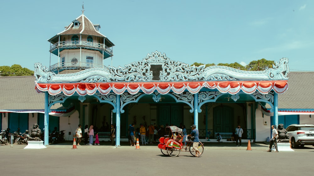 a blue and red building with a clock tower in the background