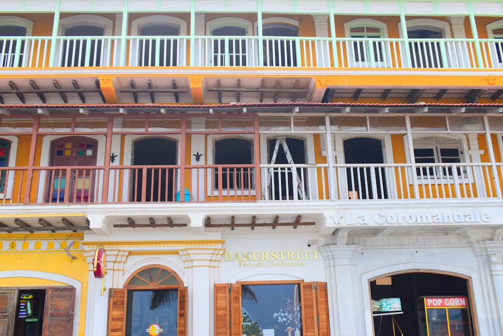 a yellow and white building with balconies and balconies