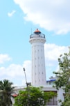 a tall white tower with a light on top