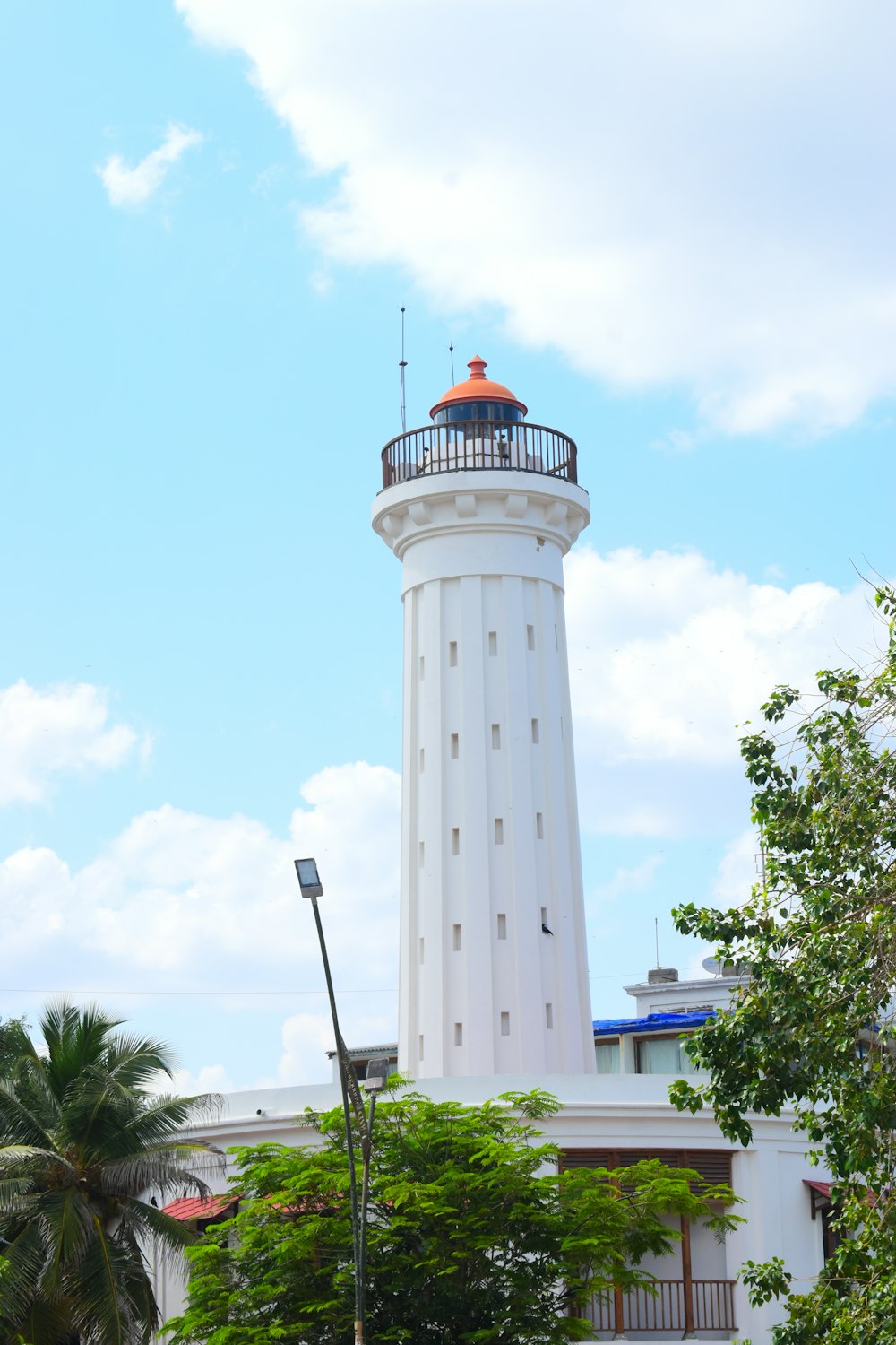 a tall white tower with a light on top