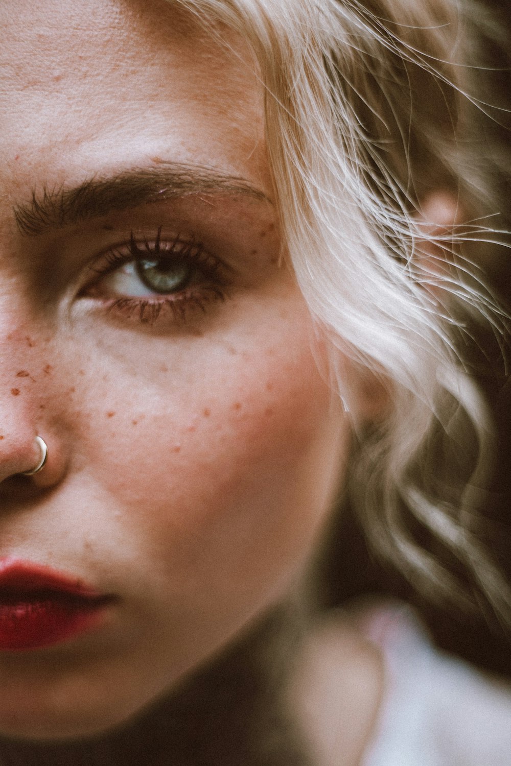 a close up of a woman with freckles on her nose