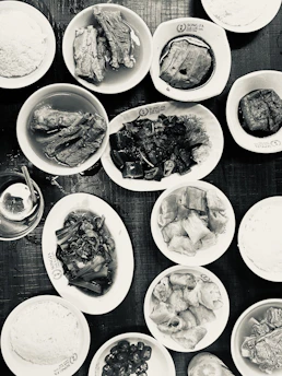 Close-up of traditional Hong Kong dishes beautifully arranged on a wooden table.