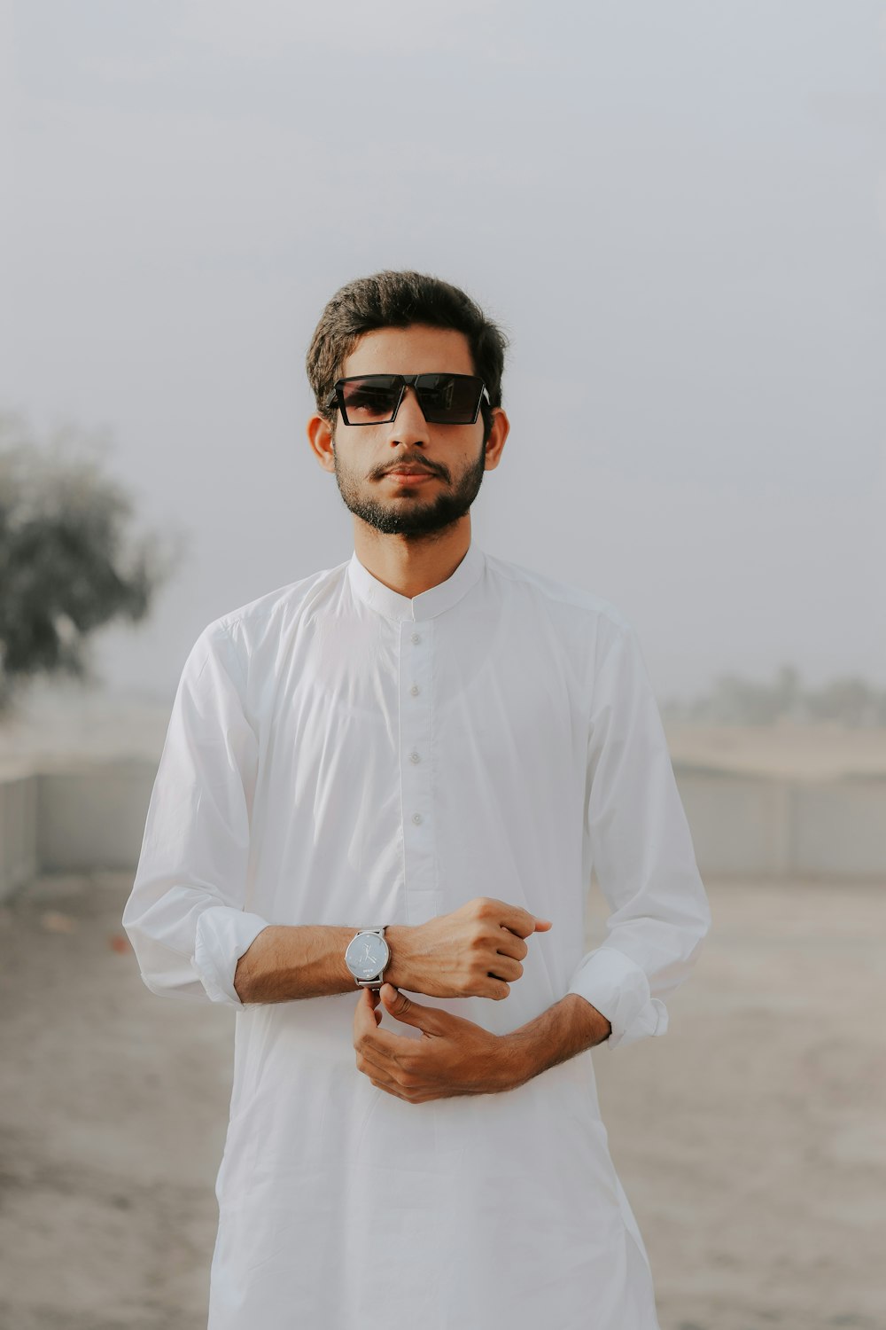 a man wearing sunglasses and a white shirt