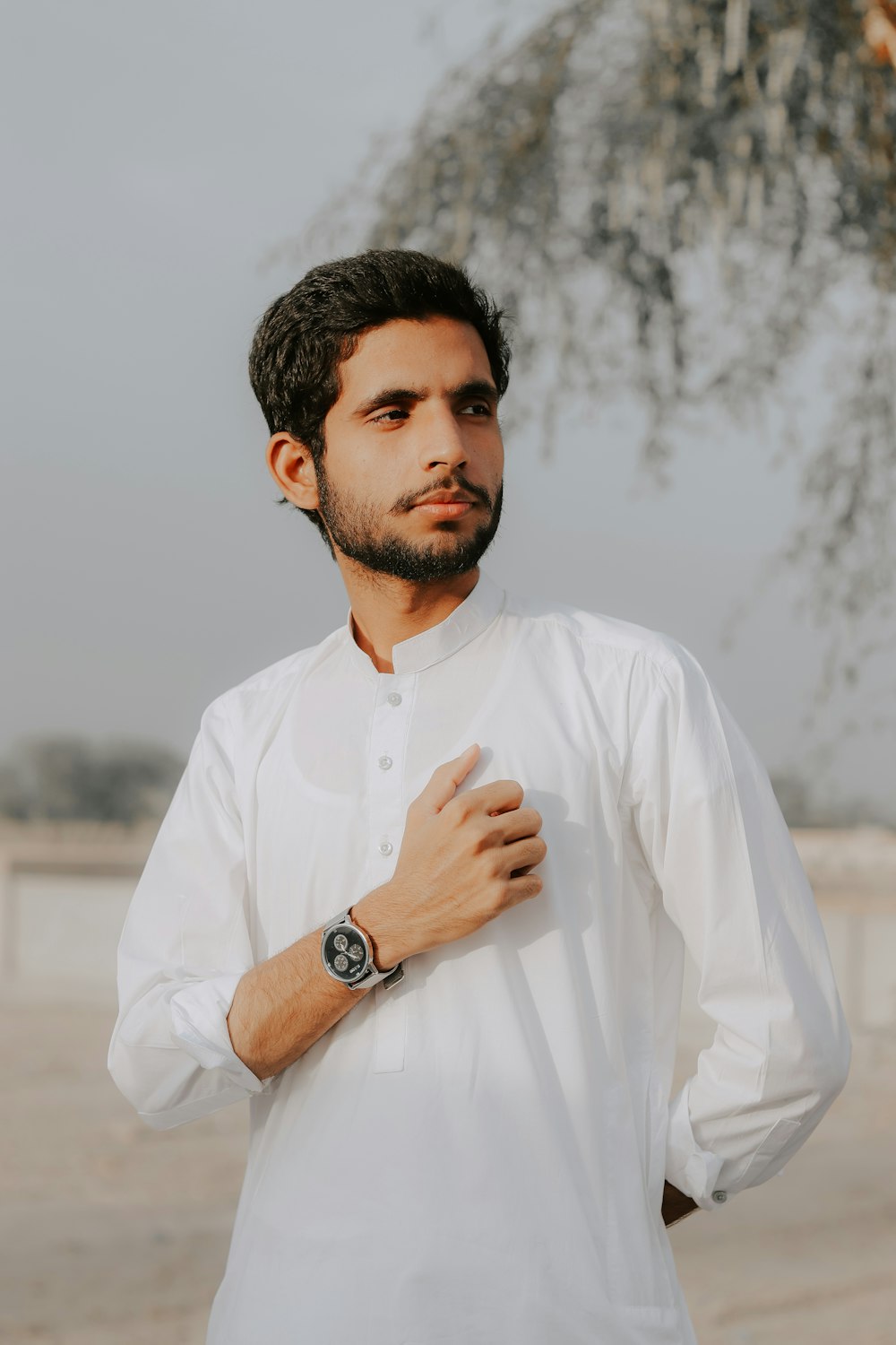 a man wearing a white shirt and a watch